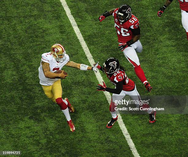 Quarterback Colin Kaepernick of the San Francisco 49ers carries the ball against Asante Samuel of the Atlanta Falcons during the NFC Championship...