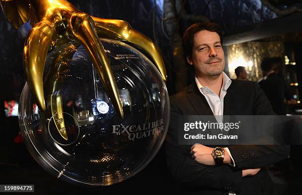 Gregory Bruttin, Director of movement development poses with the Excalibur Quatuor watch as he visits the Roger Dubuis booth during the 23rd Salon...