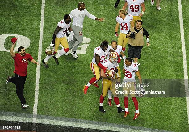 Quarterback Colin Kaepernick, Anthony Dixon, Justin Smith and Darcel McBath of the San Francisco 49ers celebrate after winning the NFC Championship...