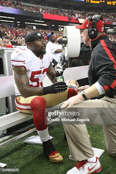 Linebackers Coach Jim Leavitt of the San Francisco 49ers talks with NaVorro Bowman during the game against Atlanta Falcons in the NFC Championship...