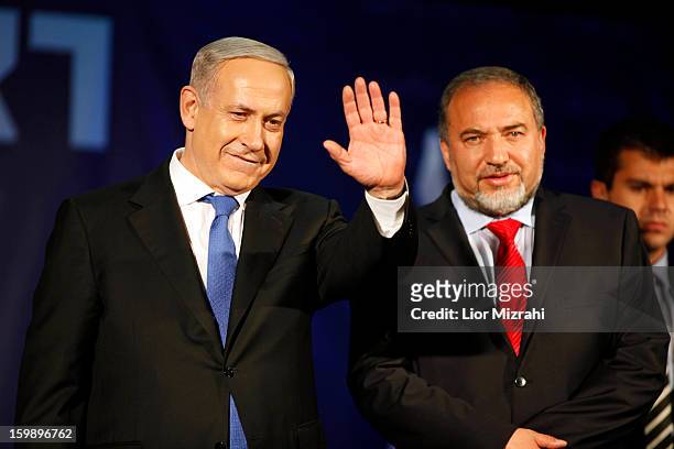 Israeli Prime Minister Benjamin Netanyahu waves to supporters with Former Israel Minister for Foreign Affairs Avigdor Liberman at his election...