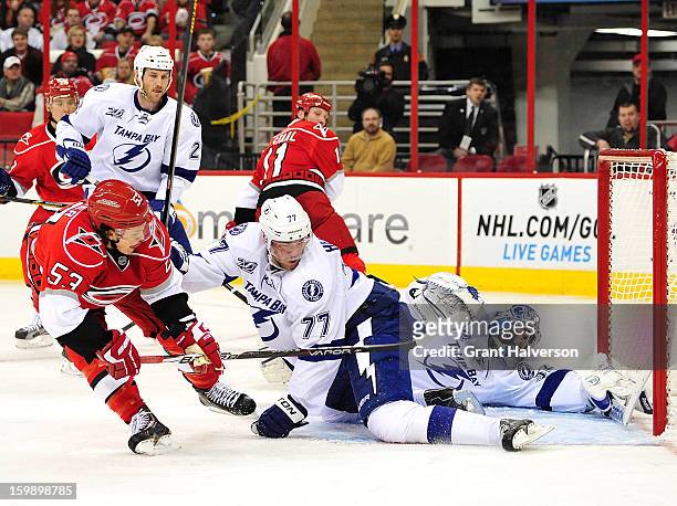 Jeff Skinner of the Carolina Hurricanes flips the puck past Victor Hedman and Mathieu Garon of the Tampa Bay Lightning for a goal during the second...