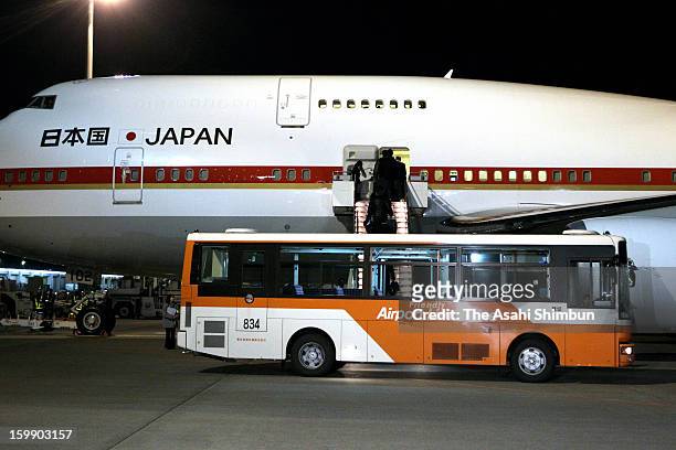 Japanese government staffs and plant constructor JGC Co staffs board to a government airplane at Tokyo International Airport on January 22, 2013 in...