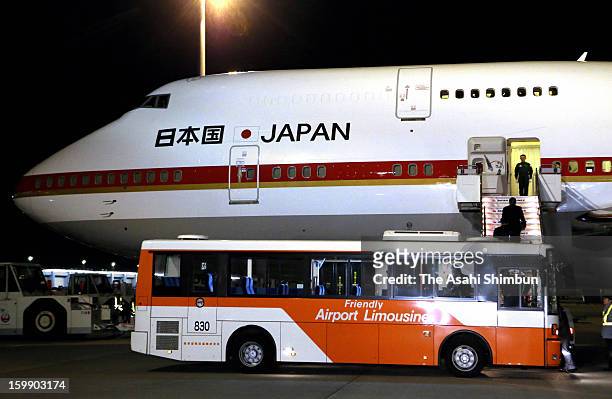 Japanese government staffs and plant constructor JGC Co staffs board to a government airplane at Tokyo International Airport on January 22, 2013 in...