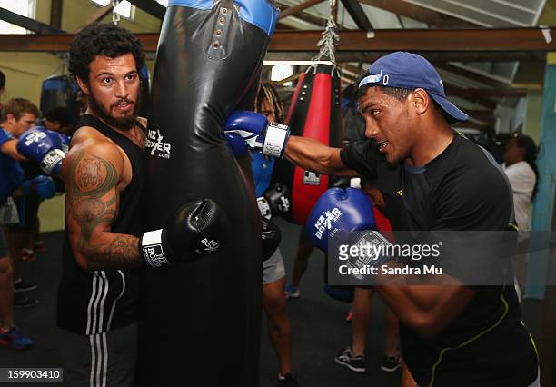 Rene Ranger hold the bag for Charles Piutau during a Blues training session with Shane Cameron at Shane Cameron Fitness on January 23, 2013 in...