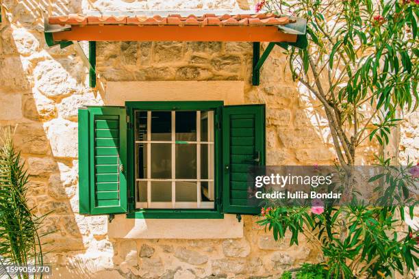 beautiful window with shutter in stone building - stone house stock pictures, royalty-free photos & images