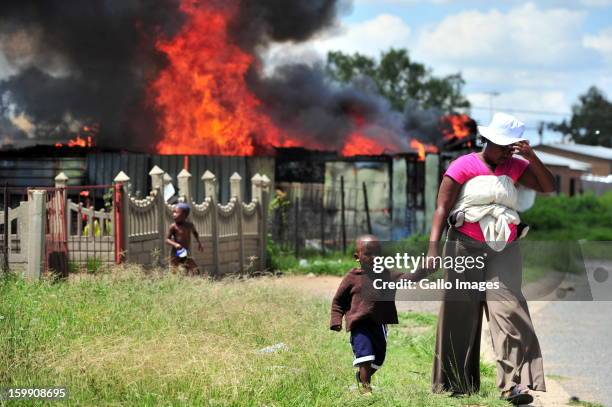 Shacks burn down on January 22 in Sasolburg, South Africa. Government's announcement of its intention to merge municipal systems in the Free State...