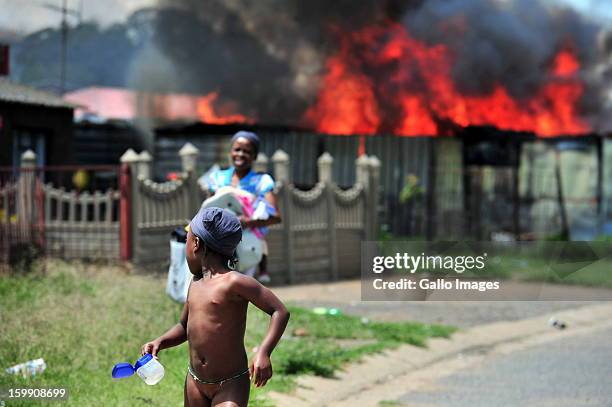 Shacks burn down on January 22 in Sasolburg, South Africa. Government's announcement of its intention to merge municipal systems in the Free State...