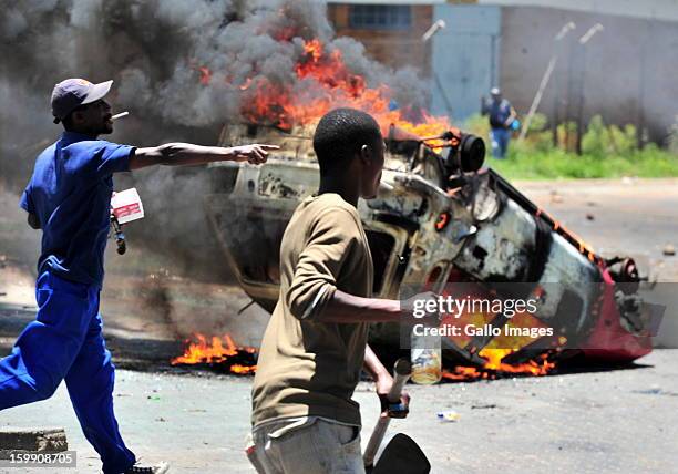 Shacks burn down on January 22 in Sasolburg, South Africa. Government's announcement of its intention to merge municipal systems in the Free State...