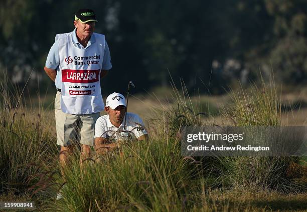 Pablo Larrazabal of Spain waits with his caddie John Curtis on the 12th hole during the first round of the Commercial Bank Qatar Masters held at Doha...