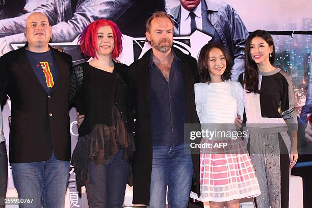 This picture taken on January 21, 2013 shows American director Andy Wachowski and his sister Lana Wachowski, British-Australian actor Hugo Weaving,...