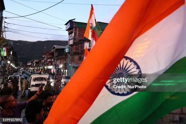 Kashmiri men wave Indian National Flag during Tiranga rally In Baramulla Jammu and Kashmir India on 14 August 2023.