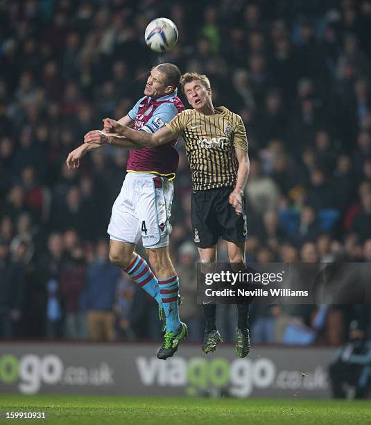 Ron Vlaar of Aston Villa challenges Stephen Darby of Bradford City during the Capital One Cup Semi-Final match Second Leg between Aston Villa and...