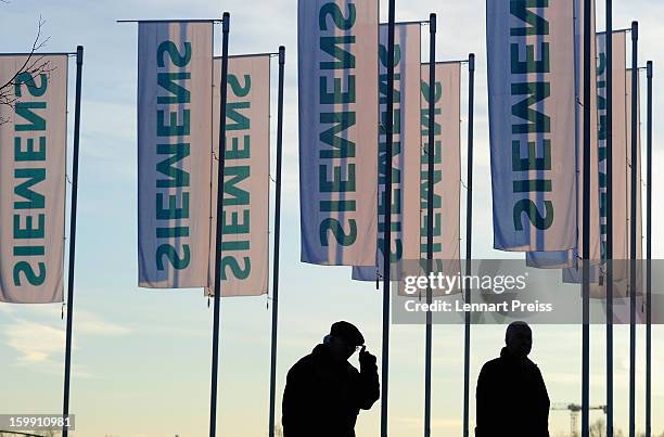 Shareholders arrive for the Siemens annual general shareholders' meeting at the Olympiahalle on January 23, 2013 in Munich, Germany. Siemens...