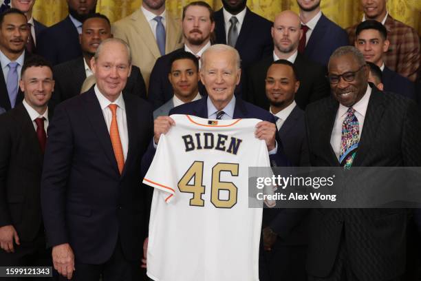 President Joe Biden is presented with a jersey by team owner and Chairman of Houston Astros Jim Crane and team manager Dusty Baker during an East...