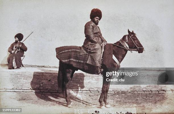 rider from turkmenistan sitting on his horse, side view, 1882 - fur hat stock illustrations