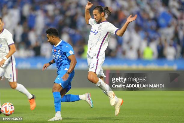 Hilal's Saudi midfielder Salem al-Dawsari is marked by Abha's Polish midfielder Grzegorz Krychowiak during the Saudi Pro League football match...
