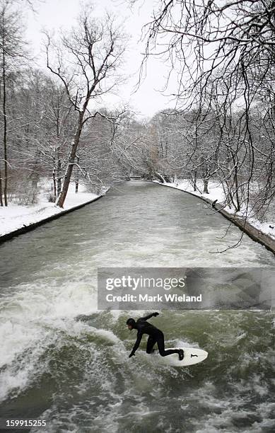 Surfer rides the Eisbach wave in the English Garden on January 13, 2013 in Munich, Germany. The man-made wave at the Eisbach , which has been surfed...