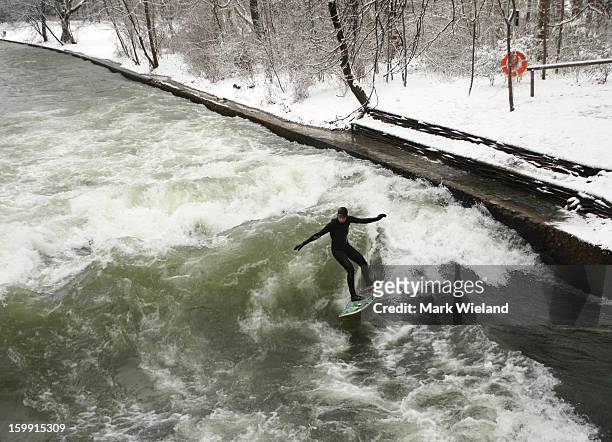 Surfer rides the Eisbach wave on January 19, 2013 in Munich, Germany. The man-made wave at the Eisbach , which has been surfed since 1972, officially...