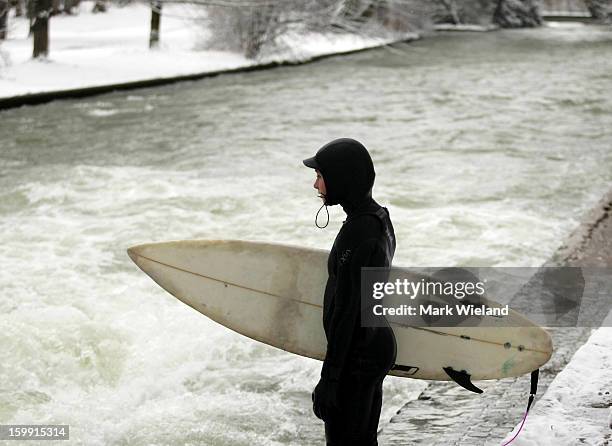 Surfer waits to enter the Eisbach in the English Garden on January 19, 2013 in Munich, Germany. The man-made wave at the Eisbach , which has been...