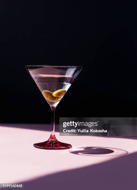evening martini cocktail bar - martini glass with olive stock pictures, royalty-free photos & images