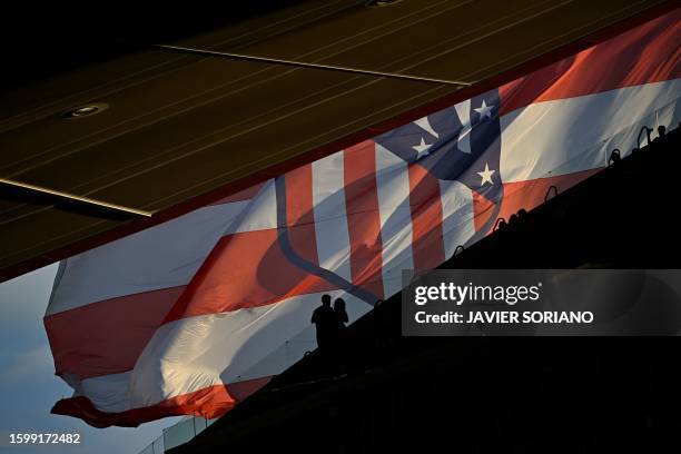 Supporters stand in front of an Atletico de Madrid's giant flag prior the Spanish Liga football match between Club Atletico de Madrid and Granada FC...