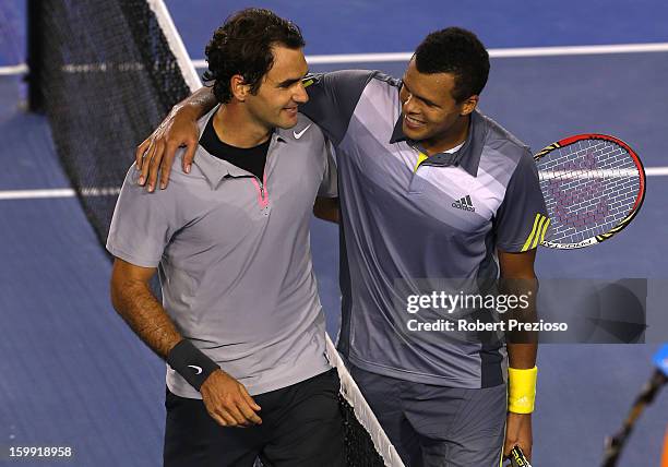 Roger Federer of Switzerland and Jo-Wilfred Tsonga of France shake hands after Federer won their Quarterfinal match during day ten of the 2013...