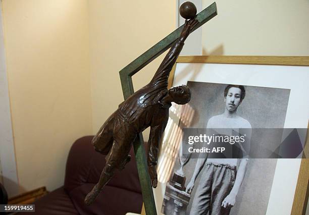 Statue and portrait of late footballer Arthur Wharton are pictured at the Ghana Football Association on January 15, 2013 in Accra, Ghana. On the...