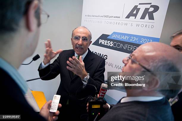 Filippo Bagnato, chief executive officer of Avions de Transport Regional , center, gestures as he speak with journalists following a news conference...