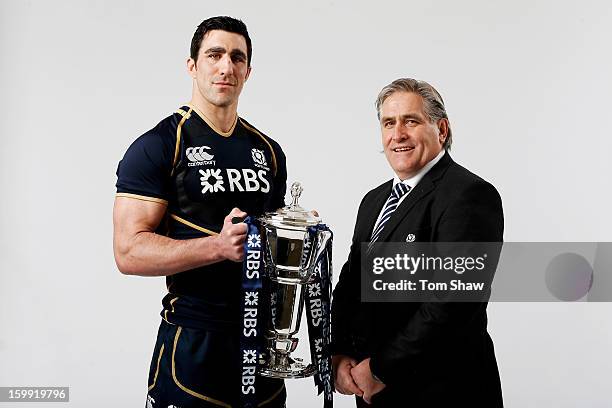 Scotland captain Kelly Brown and Scott Johnson the Scotland interim head coach pose with the Six Nations trophy during the RBS Six Nations launch at...
