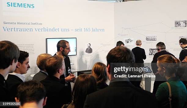 Siemens employee demonstrates an old dynamo machine during the Siemens annual general shareholders' meeting at the Olympiahalle on January 23, 2013...