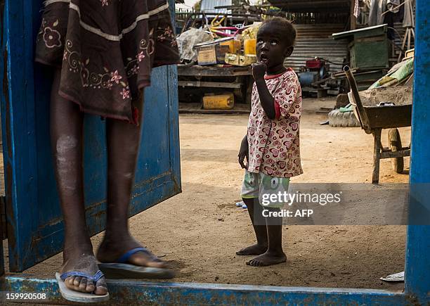 Child from South Sudan's Bari tribe stands at the entrance into a compound near Gudele market in Juba, South Sudan January 23, 2012. Gudele was the...