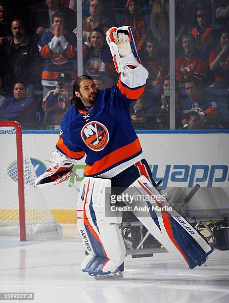 Goaltender Rick DiPietro of the New York Islanders waves to the fans during pregame introductions prior to the Islanders home opener against the New...