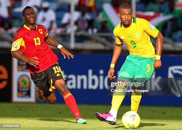 Bartolomeu Jacinto Quissanga of Angola and Katlego Mphela of South Africa during the 2013 African Cup of Nations match between South Africa and...