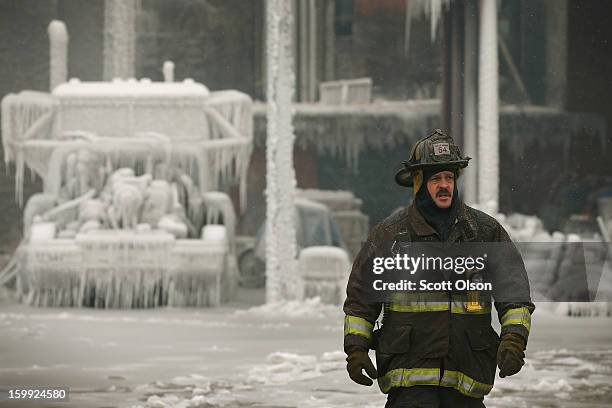 Firefighters help to extinguish a massive blaze at a vacant warehouse on January 23, 2013 in Chicago, Illinois. More than 200 firefighters battled a...