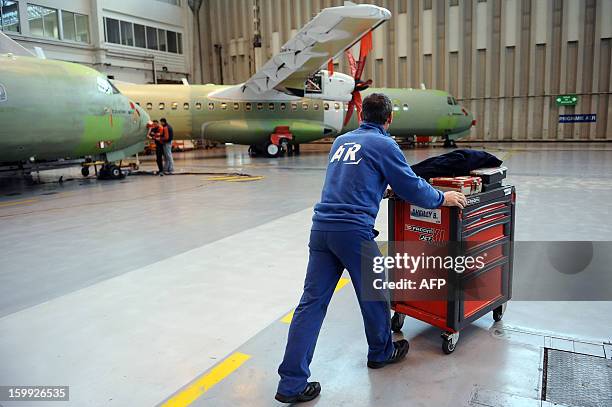 Employees of Franco-Italian aeronautics manufacturer ATR work on an assembly line on January 23, 2013 at the Toulouse factory. ATR registered for the...