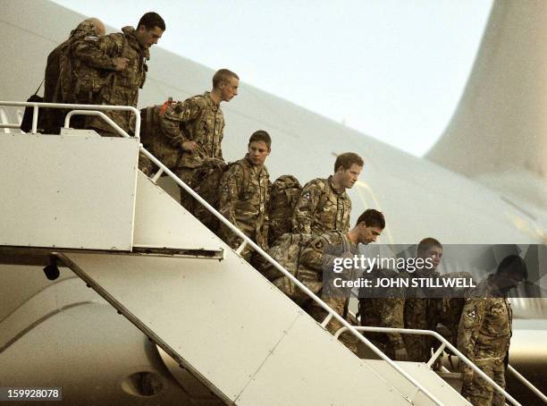 Britain's Prince Harry walks down the steps of a British Royal Air Force A-330 transport aircraft as he arrives home at RAF Brize Norton in...