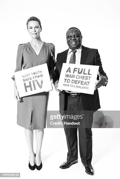 In this handout photo provided by The Global Fund, HIV and AIDS campaigner Charlize Theron and Zimbabwean Prime Minister Morgan Tsvangirai pose for a...