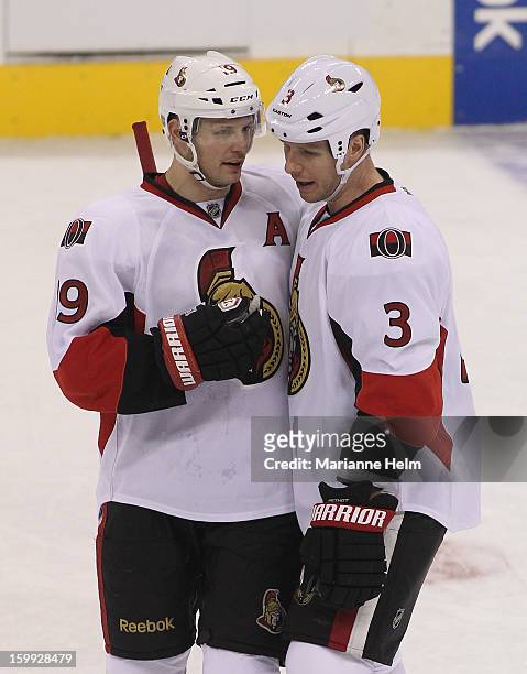 Jason Spezza of the Ottawa Senators talks with teammate Marc Methot during a break in the action in a game against the Winnipeg Jets on January 19,...