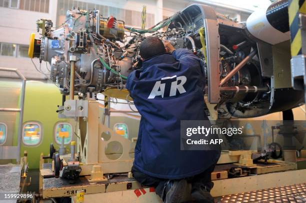 An employee of Franco-Italian aeronautics manufacturer ATR works on an assembly line on January 23, 2013 at the Toulouse factory. ATR registered for...