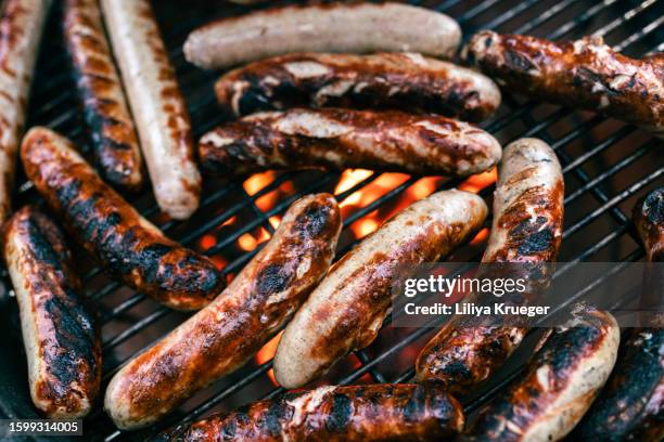 close-up of german sausages on the grill. - bratwurst stock pictures, royalty-free photos & images