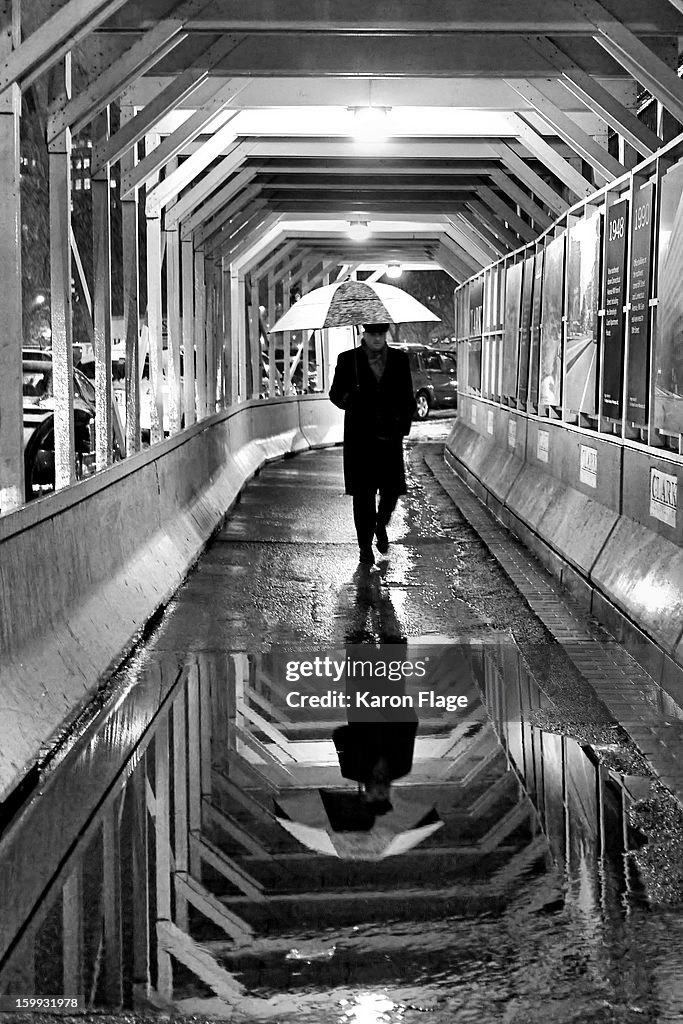 Man With Umbrella Shelters From the Storm