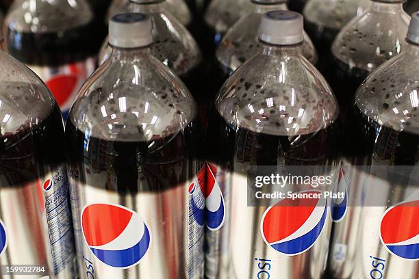 Bottles of soda are displayed on the shelf of a store on January 23, 2013 in New York City. As American consumers continue to shift to water, coffee,...