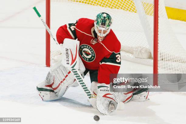Niklas Backstrom of the Minnesota Wild makes a save against the Colorado Avalanche during the game on January 19, 2013 at the Xcel Energy Center in...