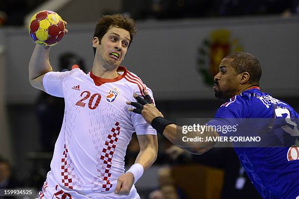 Croatia's left back Damir Bicanic vies with France's pivot Didier Dinart during the 23rd Men's Handball World Championships quarterfinal match France...