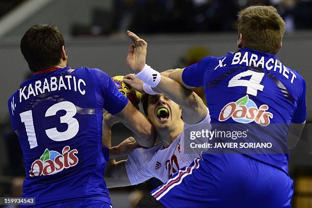 Croatia's left back Damir Bicanic vies with France's right back Xavier Barachet and France's centre back Nikola Karabatic during the 23rd Men's...