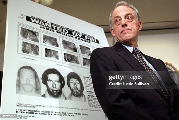 Dennis Nerney , the U.S. Attorney's antiterrorism coordinator, stands in front of an enlarged FBI wanted poster for Symbionese Liberation Army...