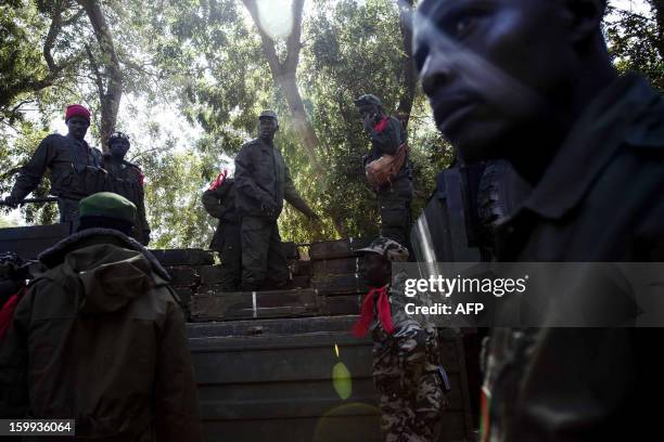 Malian soldiers load weapons cases on a truck at Niono's headquarters on January 23, 2013. The regional bloc, the Economic Community of West African...