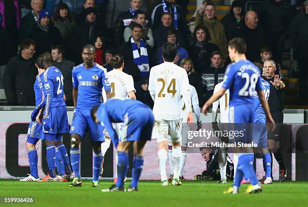 Ball boy lays on the ground after being kicked by Eden Hazard of Chelsea who is then sent off during the Capital One Cup Semi-Final Second Leg match...