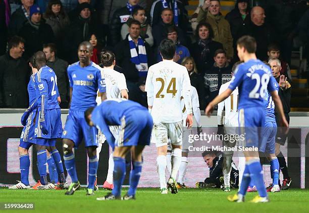 Ball boy lays on the ground after being kicked by Eden Hazard of Chelsea who is then sent off during the Capital One Cup Semi-Final Second Leg match...